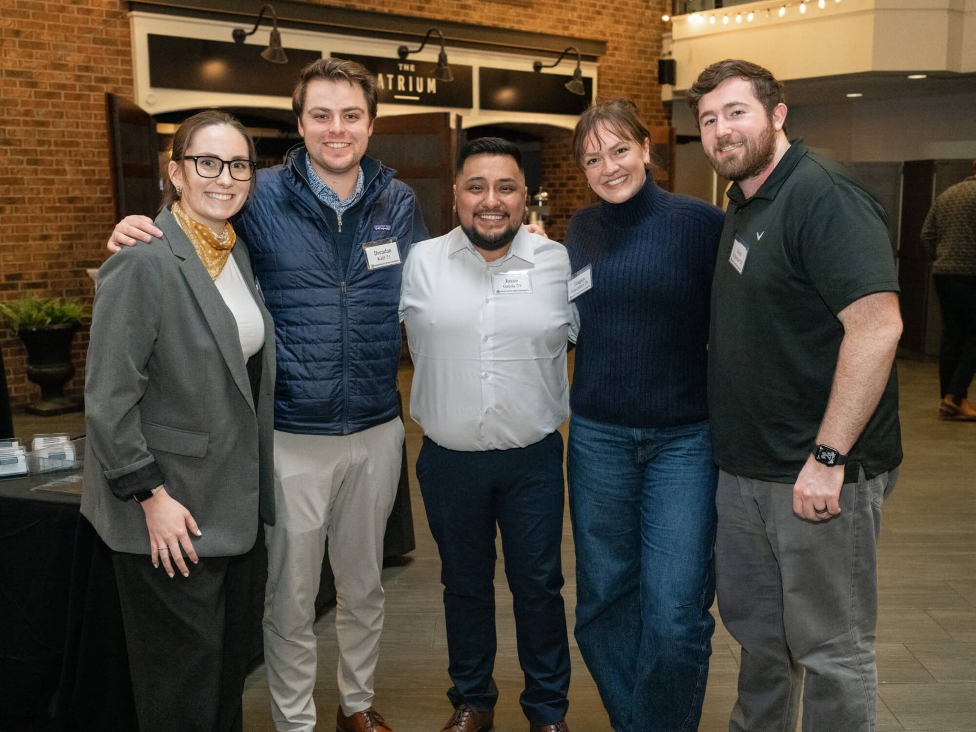 Members of the Young Alumni Council smile at an event